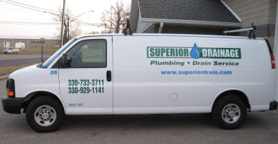 Superior Drain's white commercial van displaying their green logo, number and site link