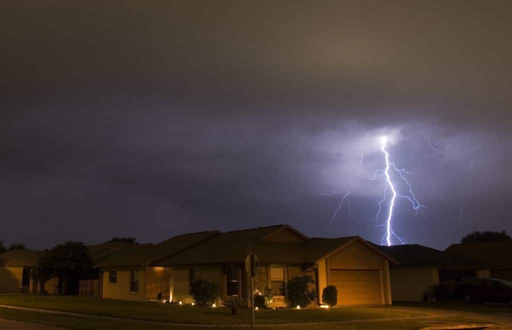 Lightning strikes during a storm near family houses