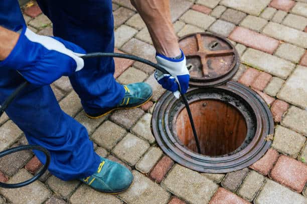 sewer cleaning service - plumber clean a clogged drainage with hydro jetting